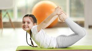 Little girl is doing yoga