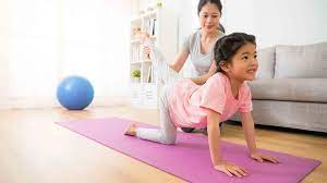 Mother is teaching yoga to her daughter